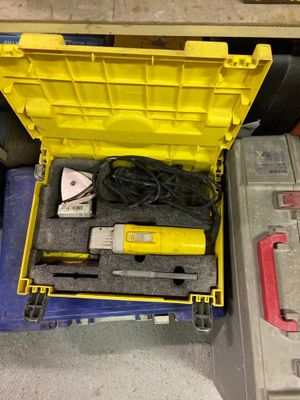 une boîte jaune contenant des outils, posée par terre