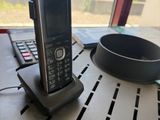 a cell phone sitting on top of a table next to a laptop
