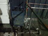 a dirty room with a broken washer and dryer on the floor
