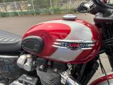a close up of a red and white motorcycle parked in a parking lot