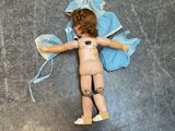 a doll that is laying down on the floor