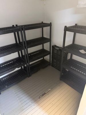 a room that has shelves and bins in it