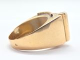 a close up of a gold ring on a white surface