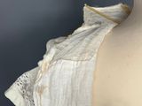 a close up of a mannequin wearing a white dress with a ruffled collar