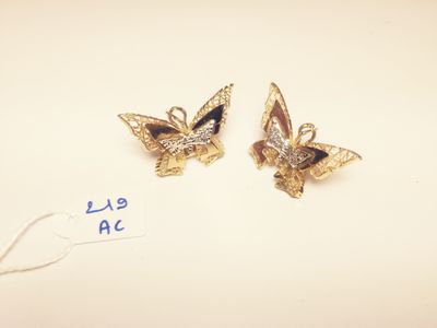 pair of gold tone butterfly earrings with black and white crystals