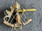 a close up of a brass bow and arrow on a carpet