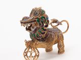 gold and enamel figurine of a lion on a cart