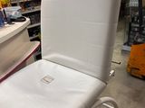 a white chair that is sitting in a store
