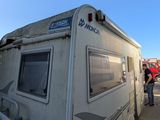 a white rv that is parked on the side of the road