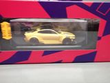 a yellow toy car in a box on a table