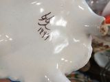 a white pig figurine sitting on top of a table