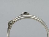 an image of a close up of a silver ring on a table