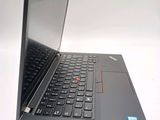 a black laptop with a red button on the keyboard