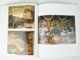 a book opened to show a picture of a painting