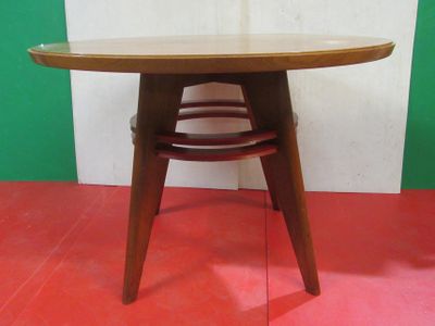 a wooden table with a red floor and a green wall