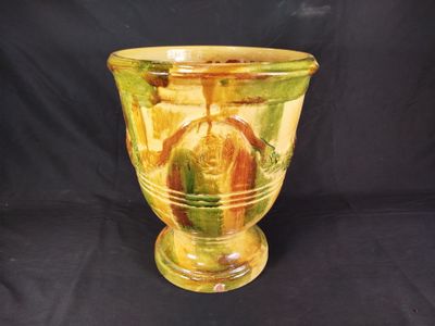 a glass vase with a yellow and green design on it