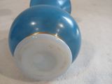 two blue and white vases on a white surface