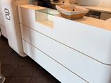 a white counter with a mirror on top of it