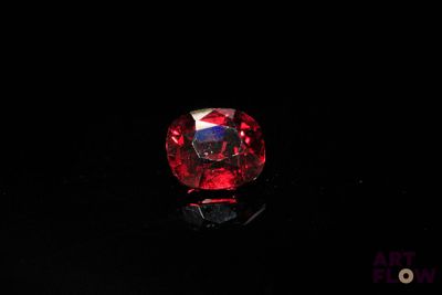 a close up of a red diamond on a black surface