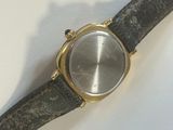 a watch that is sitting on a piece of leather