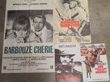 several movie posters on a table in a room