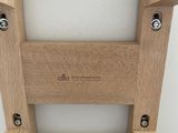 a wooden chair that has a seat made of wood
