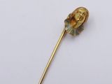 an image of a gold stick with a head of a woman