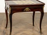 a small table with a chess board on top of it
