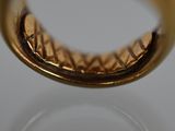 a gold ring with a diamond in it on a table