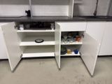 a white cabinet with a black counter top and a black counter top