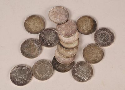 a pile of coins sitting on top of a white table