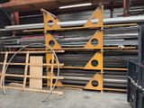 a large stack of metal pipes and pipes in a warehouse