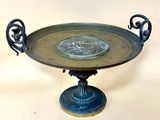 a metal tray with a decorative design on top of it
