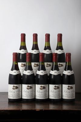 six bottles of wine are lined up on a table