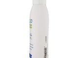 a bottle of white liquid sitting on top of a white surface