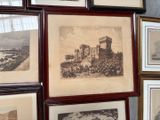 many framed pictures on the wall of this room