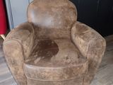 a brown chair that is sitting on a hard wood floor