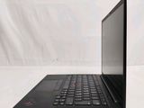 a black laptop computer sitting on a white surface