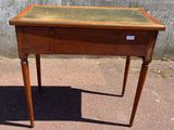 a small wooden table with a glass top on it