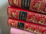 several books stacked on top of each other on a table