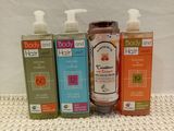 three bottles of body and body care products sitting on a table