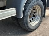 a close up of a flatbed truck with a flat tire