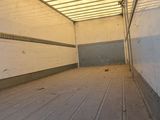 an image of a long empty room with a phone on the floor