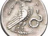 an image of a coin with a bird and snake on it