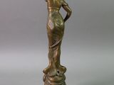 bronze statue of a woman with a flower in her hair