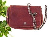 a brown purse with a chain hanging from it ' s side