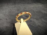 a close up of a gold ring on a black surface