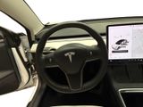 the interior of a car with a steering wheel, dashboard, and monitor