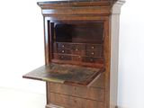 an old wooden desk with a marble top
