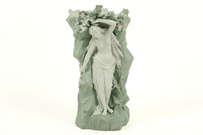 a figurine of a woman with flowers on her head